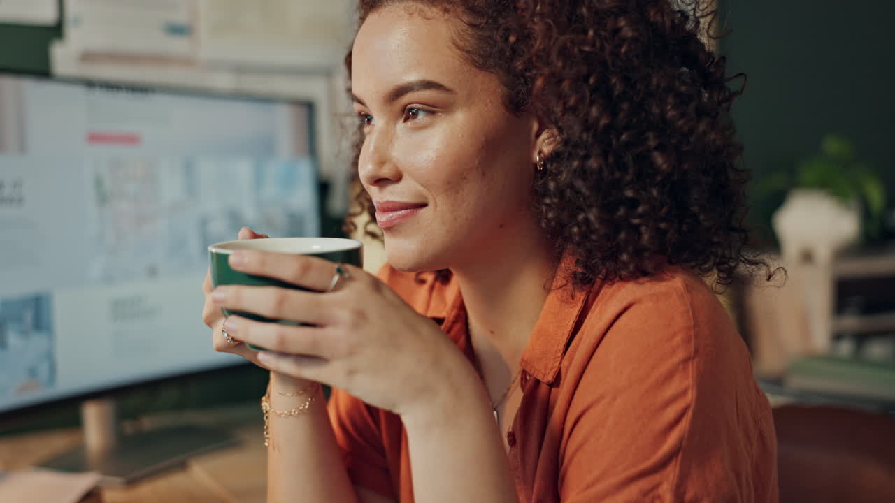 Woman working at her desk with a cup of coffee