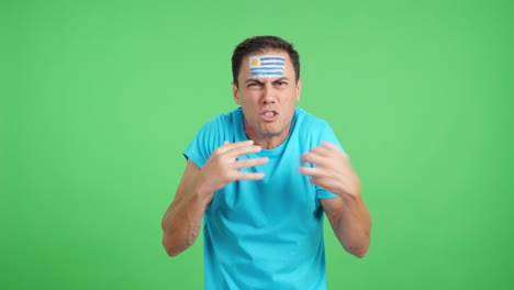man cheering for uruguay, angry with the decision of referee