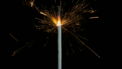 christian sparklers, bengal lights on black background. firework sparkler burning on dark background. closeup