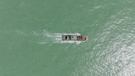top down aerial footage of a fishing trawler sailing on the ocean off the coast of the gambia