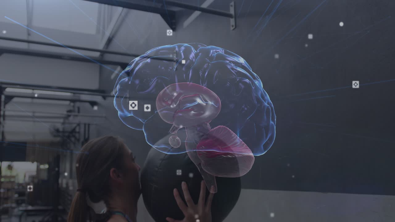 Woman stepping back raising medball, tossing catching off wall while 3D-brain showing data, fitness