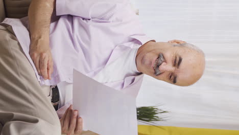 Vertical-video-of-The-old-man-who-rejoices-in-good-content-paperwork.