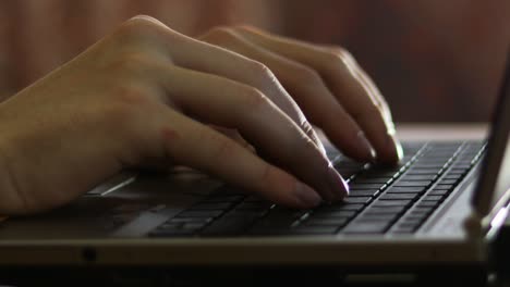 young business man's hands typing on notebook keyboard, side view selective focus.