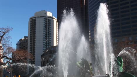 the camera pans up the four seasons' fountains and the highrises in the background