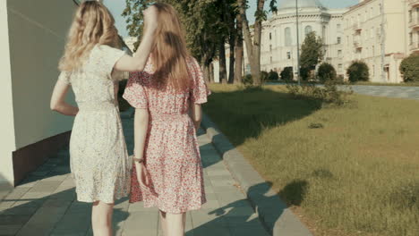 two women walking on city street