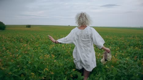 beautiful blonde runs across the field