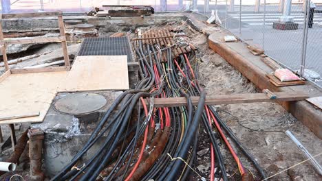 exposed pipes, conduit and electrical wiring under the city streets of new york city