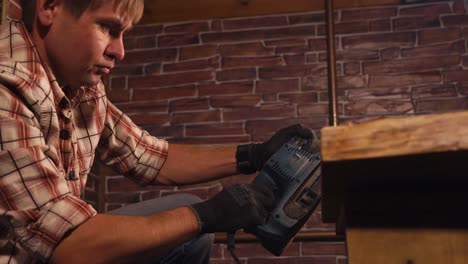 man sanding wood table