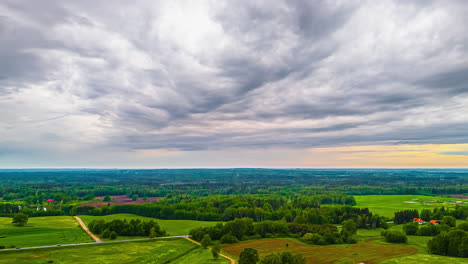 storm clouds sweeping over colorful rural countryside in fast motion with gading golden orange glow