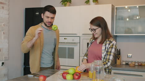 happy couple cooking in kitchen