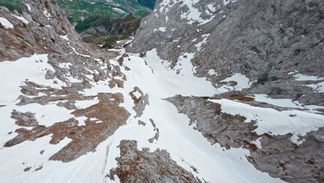 fpv drone flying over snow-covered concarena mountain, showcasing rugged terrain and natural beauty