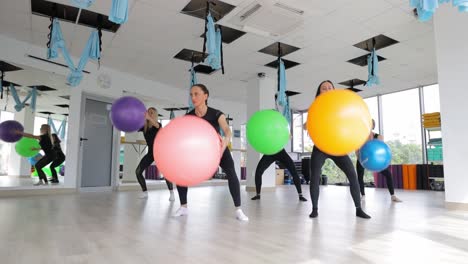 women exercising with stability balls in a group fitness class
