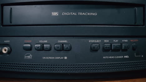 inserting vhs cassette into a vintage vcr