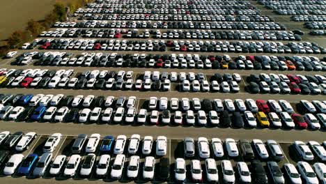 Aerial-footage-of-finished-cars-ready-to-be-shipped-on-huge-distribution-center