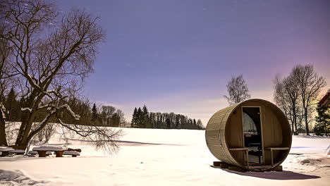 time lapse barrel sauna sunset snowy landscape