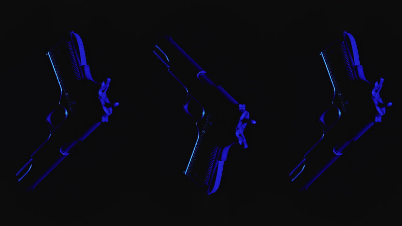 Pistols on the dark background and in blinking red and blue light rotate in slowmotion