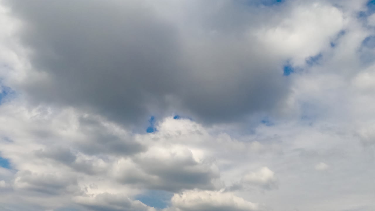 Beautiful white cloudscape formation in the azure sky. Clouds changing shape quickly in the atmosphere. Low angle view. Timelapse.