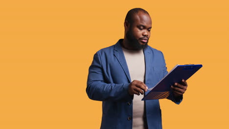 man scratching head, feeling puzzled while browsing though financial audit