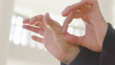 close up view of moving hands of contemporary dancer in the studio