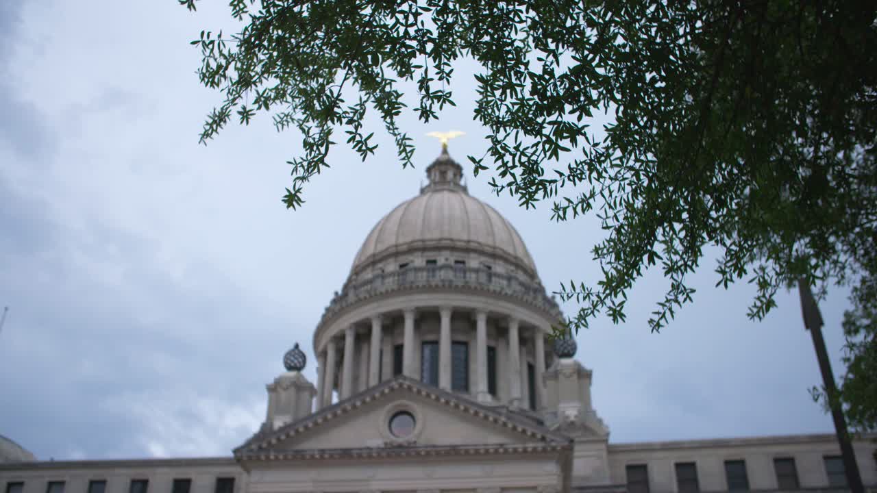 Foreground focus, medium: Stormy skies over the Mississippi State Capitol building. Jackson, MS