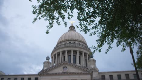 foreground focus, medium: stormy skies over the mississippi state capitol building. jackson, ms