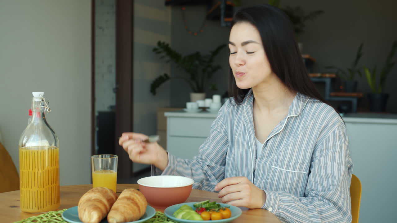 Woman enjoying breakfast at home