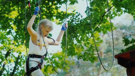 A-Brave-Child-Walks-Along-A-Tightrope-Between-Tall-Trees-Active-Childhood-And-Fun