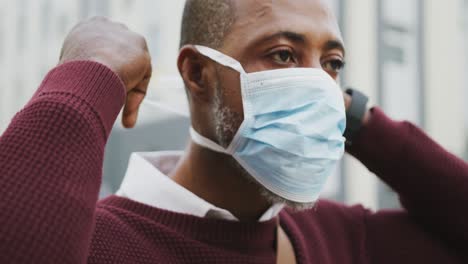 african american man on the go wearing coronavirus covid19 mask