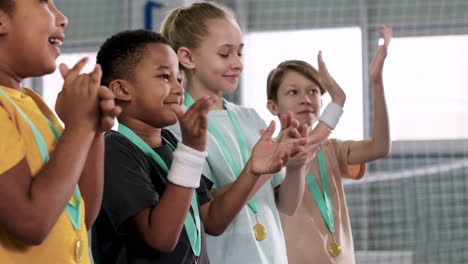 kids receiving gold medal