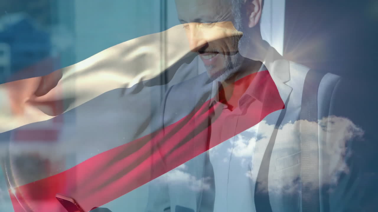 Using smartphone with waving flag animation, man smiling