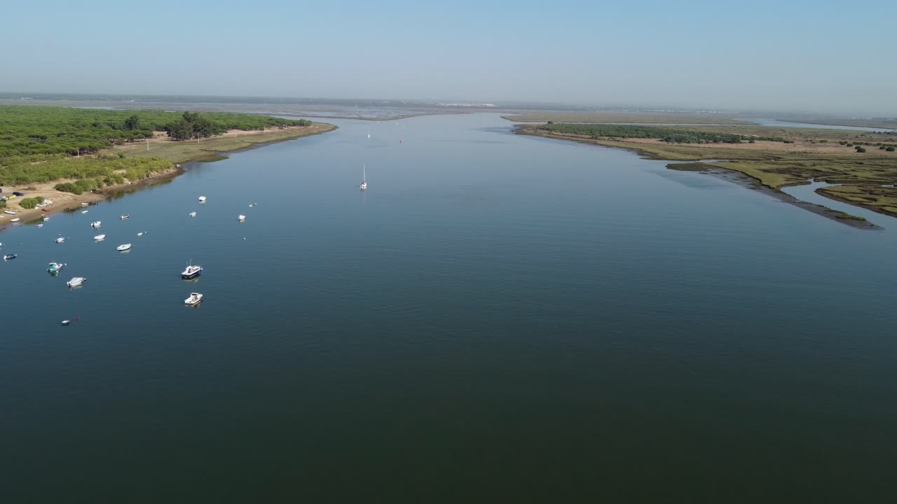 Boats anchored in the wetland area at the mouth of the river Odiel in Spain