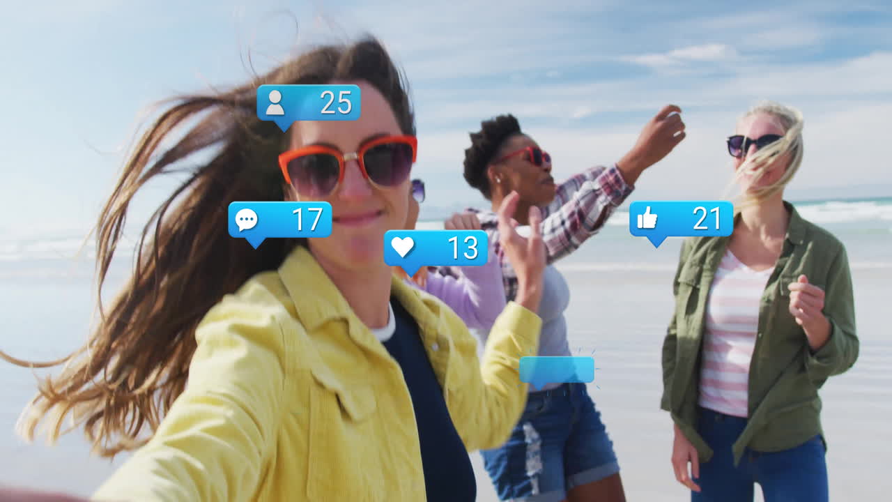 On beach, diverse friends interacting with animation of social media notifications