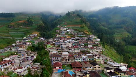 remote village terraced houses and fields on mount sumbing slope, java, aerial