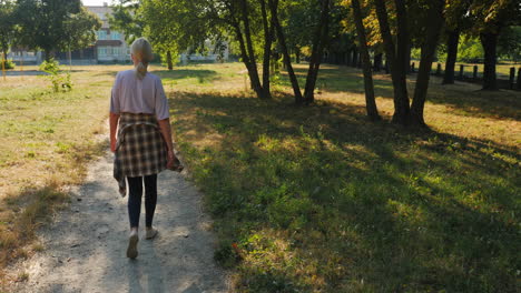 woman walking in a park on a sunny day