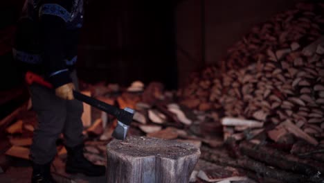 man chopping firewoods with axe in indre fosen, norway