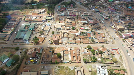 aerial of a busy town in rural kenya - drone flying backwards