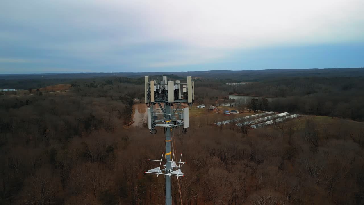 Aerial Shot Rotating Around Cell Phone Tower with Forest in Background. 4K Drone