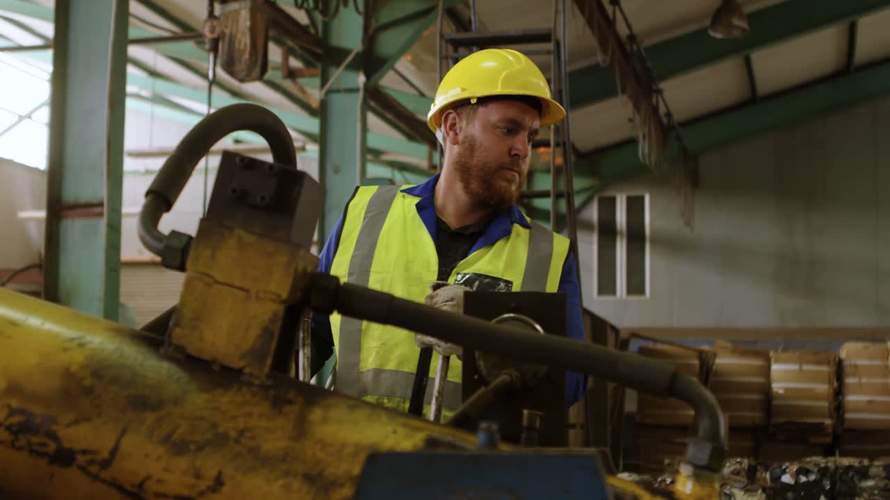 Male worker working on machine in warehouse 4k