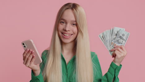 happy woman looking smartphone display rejoicing win celebrating receiving money dollar cash jackpot