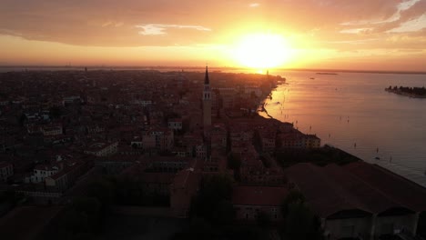 sunset in venice summer, italian touristic sea destination, aerial drone above city, coast, campanile tower and residential buildings