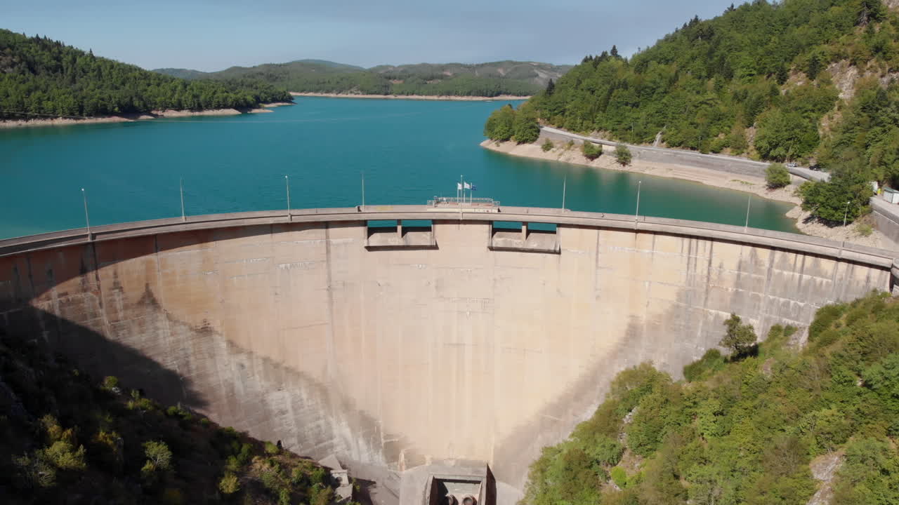 Aerial View of a Large Dam and Reservoir in a Mountainous Region