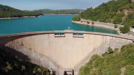 aerial view of a large dam and reservoir in a mountainous region