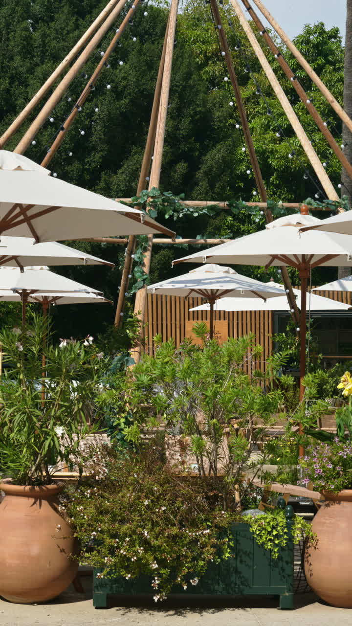 White umbrellas at a terrace in Monte Carlo, Monaco. Vertical