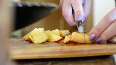 a macro video of someone cutting a peach