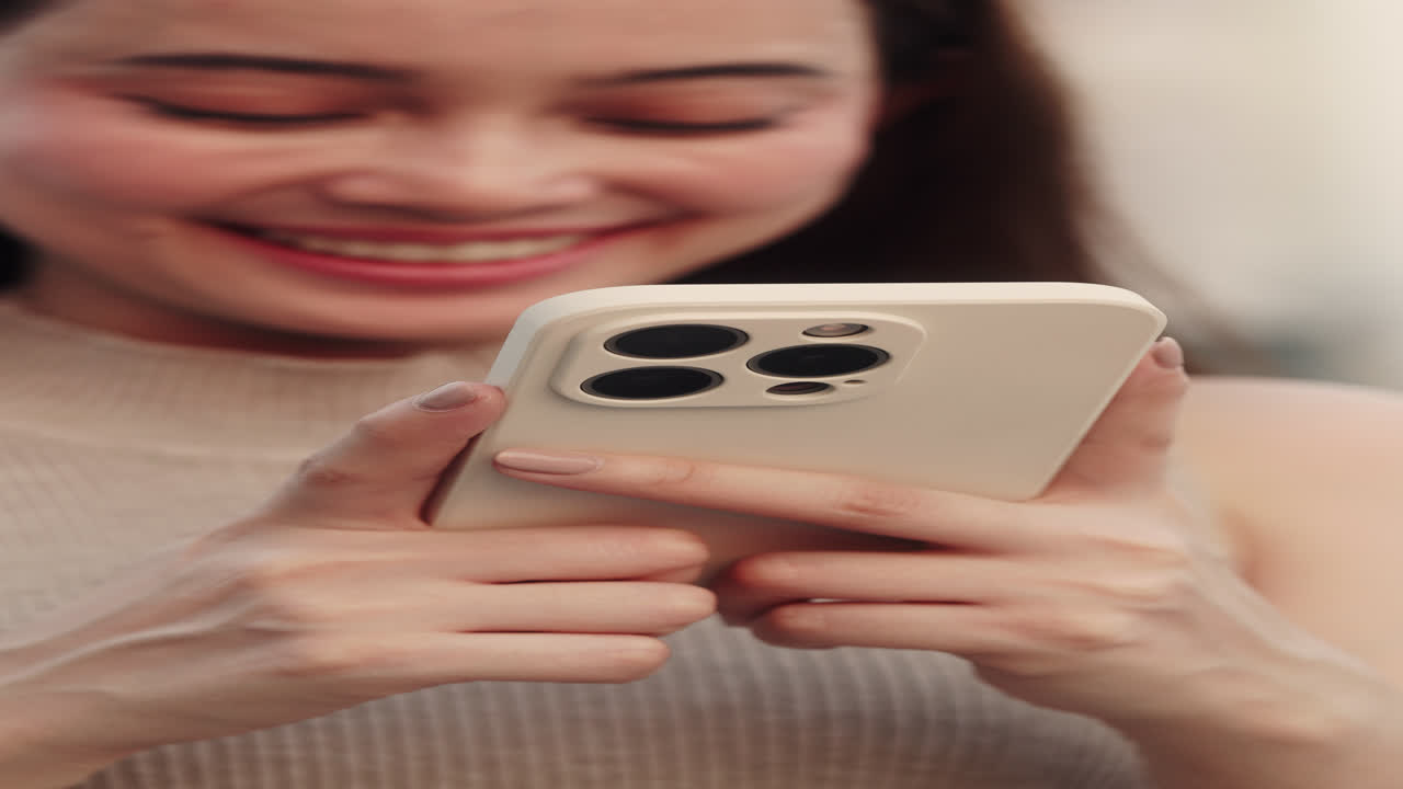 Happy Woman Holding Smartphone and Smiling