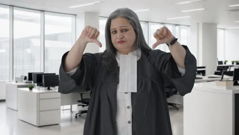 disappointed indian senior female lawyer showing thumbs down