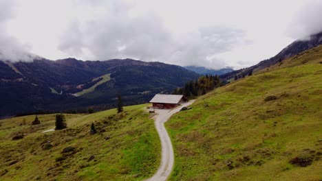 Huts-houses-on-ski-resort-in-Autumn-fall,-Austrian-alps-landscape,-aerial-shot