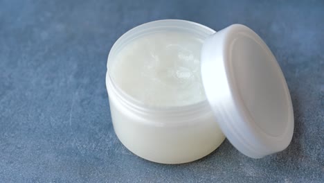 open white plastic jar of cream