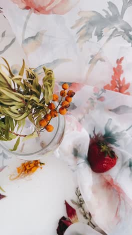 floral still life with berries and strawberry