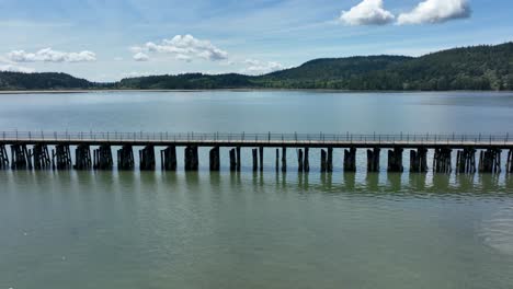 tight shot of a bridge crosses a shallow bay of water in washington